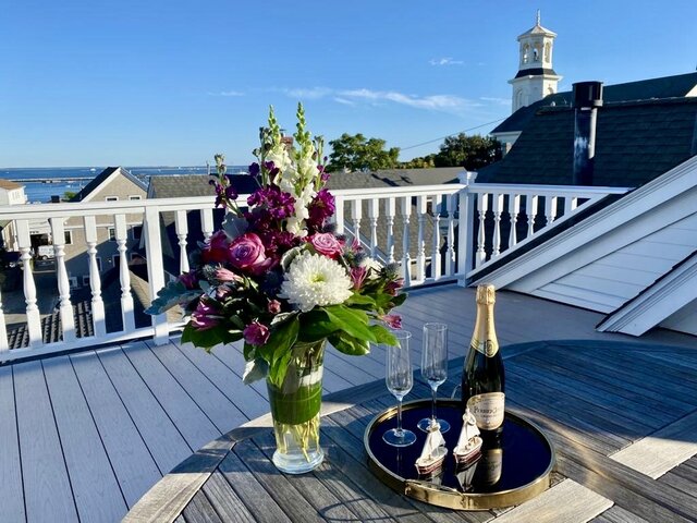 Spectacular bay and town views from atop the private roof deck of the Hatches Harbor Suite