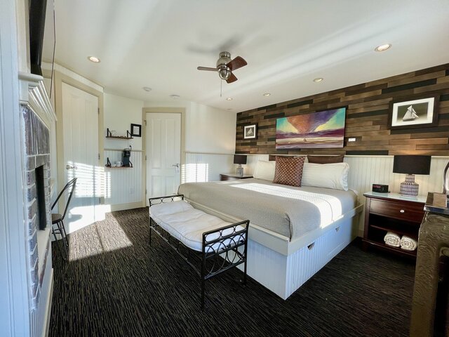 King Bed, fireplace, and writing desk of the Race Point Room of our Ptown B&B