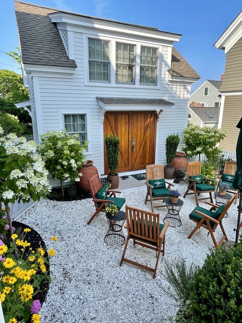 Exterior of carriage house with Nobska Light on the 2nd floor overlooking the garden