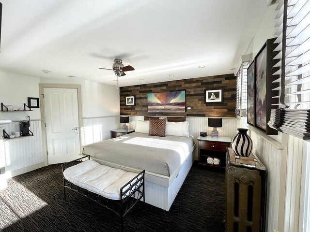 Race Point King room with art, king bed, and working space