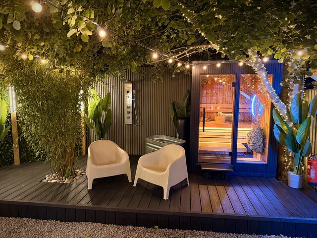 Tropical jungle-style outdoor area featuring hanging plants from the roof, floor planter, a refreshing plunge pool, outdoor shower and two relaxing chairs, creating a peaceful nature-inspired retreat