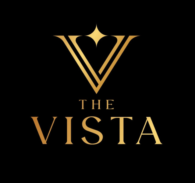 The Vista logo at The Secret Garden Glamping featuring a modern ‘V’ with a diamond in the center, and ‘The Vista’ written underneath, representing the stylish and luxurious brand identity.