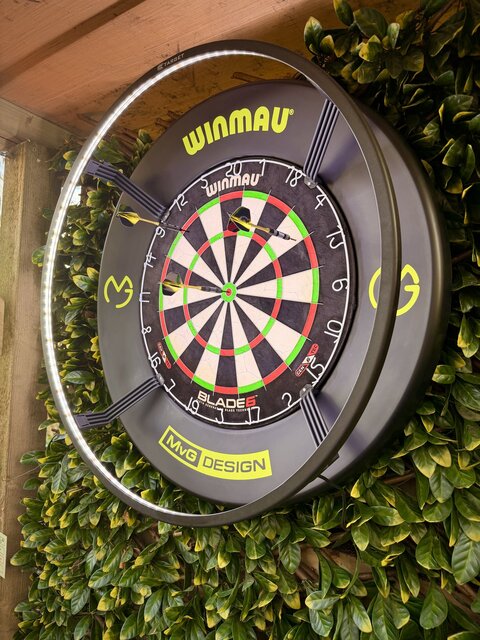 “Close-up of a lit dartboard in the outdoor entertainment area, ready for a game and adding a fun, stylish touch to The Secret Garden Glamping experience.”