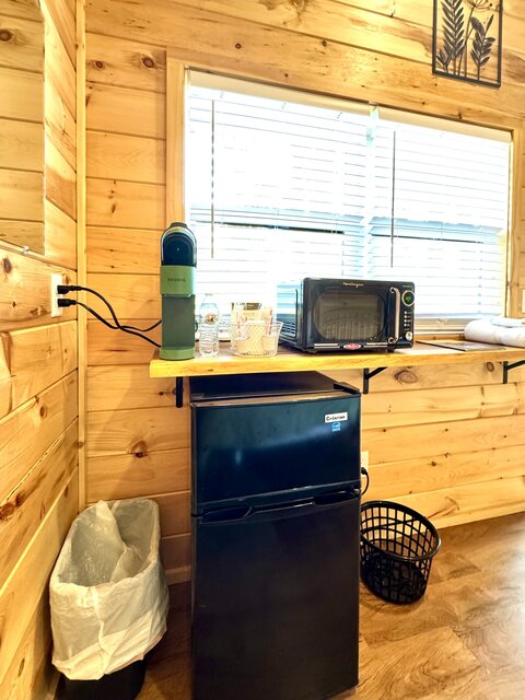 Cabin interior view of mini bar with microwave, frig, coffee
