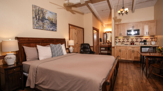 king bed with view of kitchenette and vanity