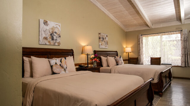 2 queen beds view towards window with lace urtains