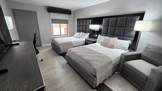 Room showing two double beds