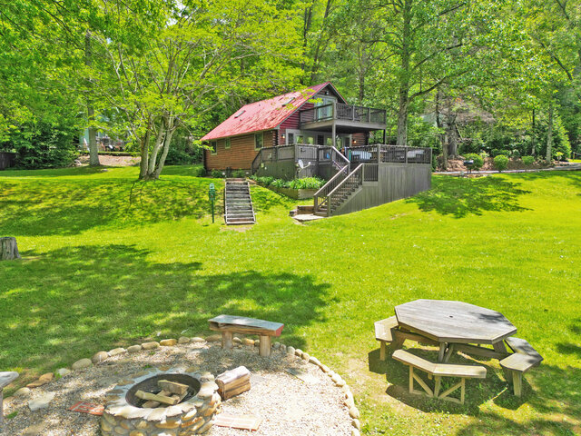 Waters Edge Cabin Rental exterior with outdoor firepit
