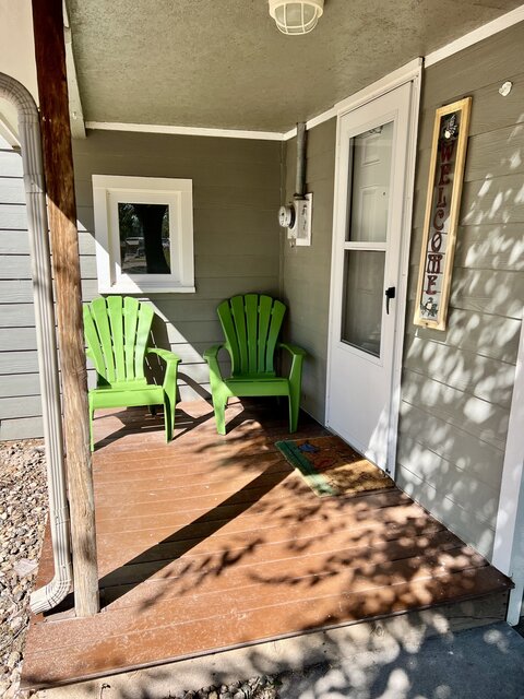 two Adirondack chairs on porch