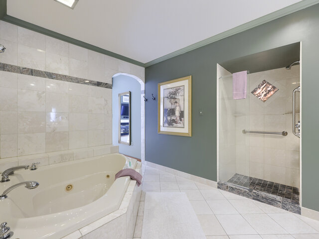 Jacuzzi in Spacious Bathroom with Archway