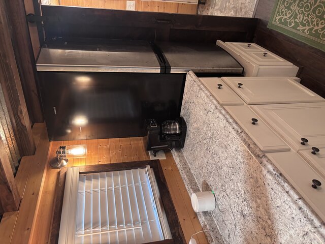 Kitchen w/ fridge, coffee maker, toaster oven, cooking eye.