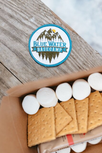 Bowl of chocolate pieces with a stack of graham crackers and pile of marshmellows.Bowl of chocolate pieces with a stack of graham crackers and pile of marshmellows.